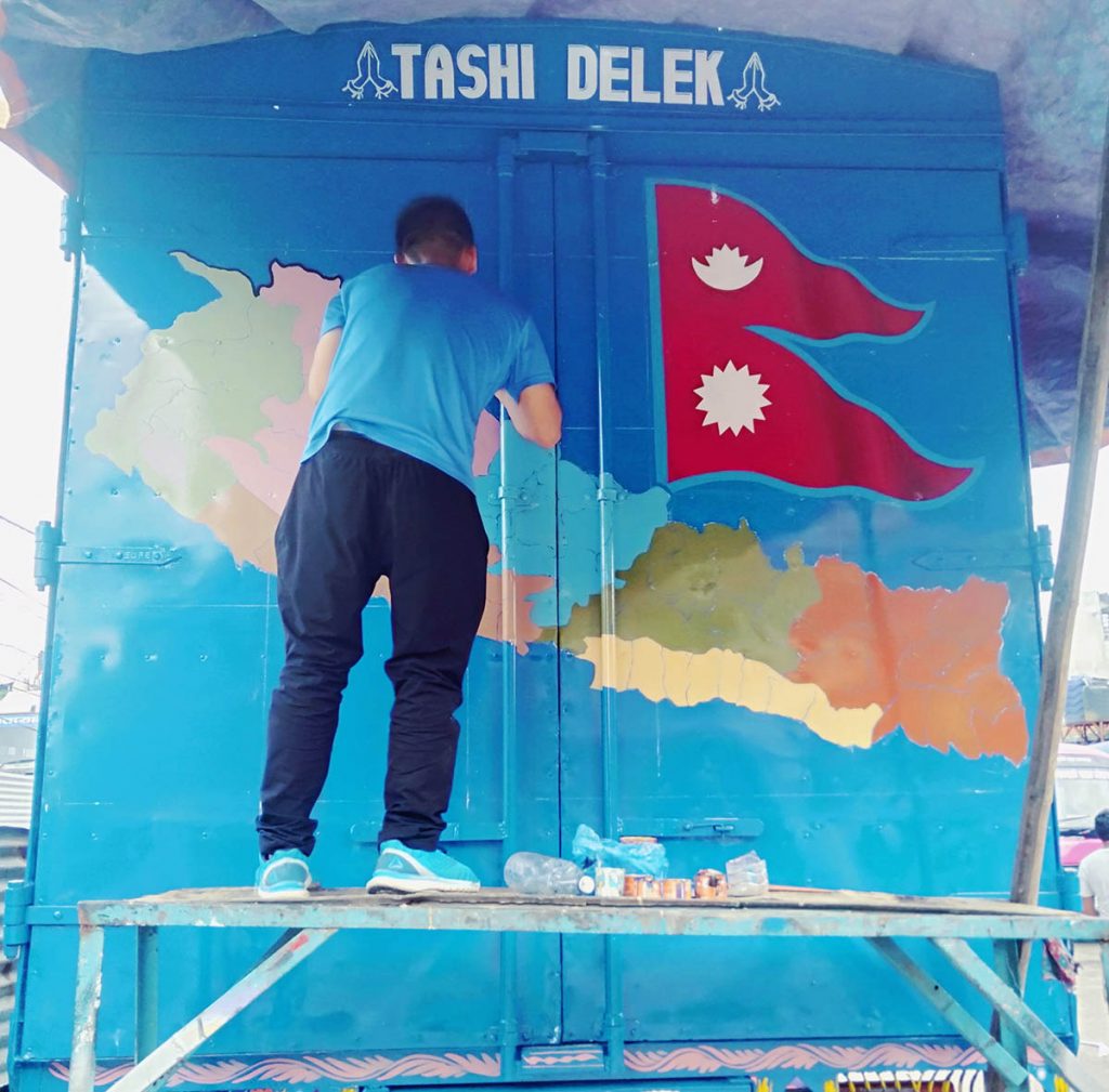 Artist drawing a Nepal new map in container truck