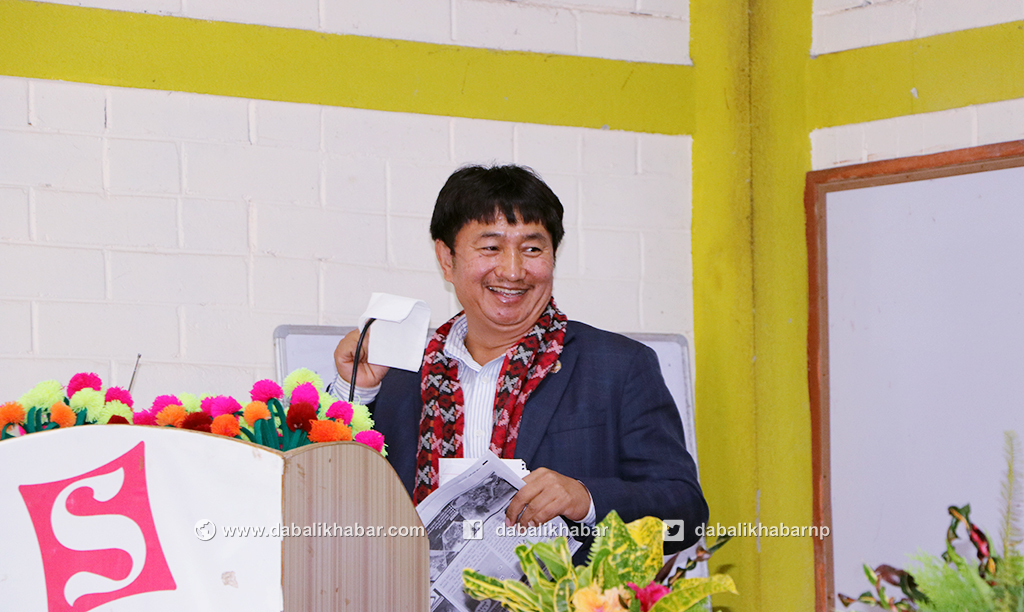 bahadur singh lama putting a tissue paper in mouthpieces mike in Uttaragaya daily anniversary program nuwakot