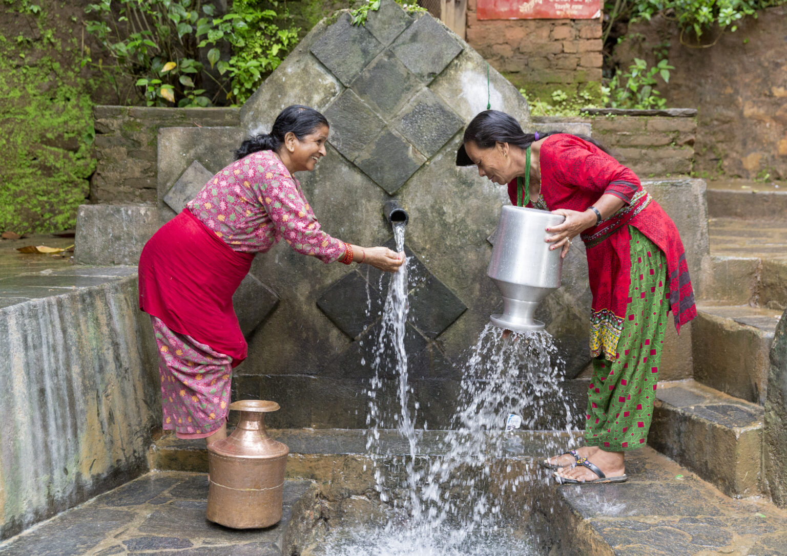 two women collecting water in Bidur Rawaldhara nuwakot
